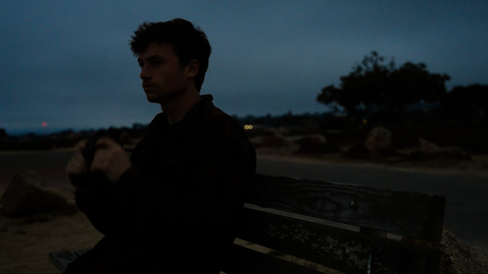 Dakota Martin with a film camera at blue hour