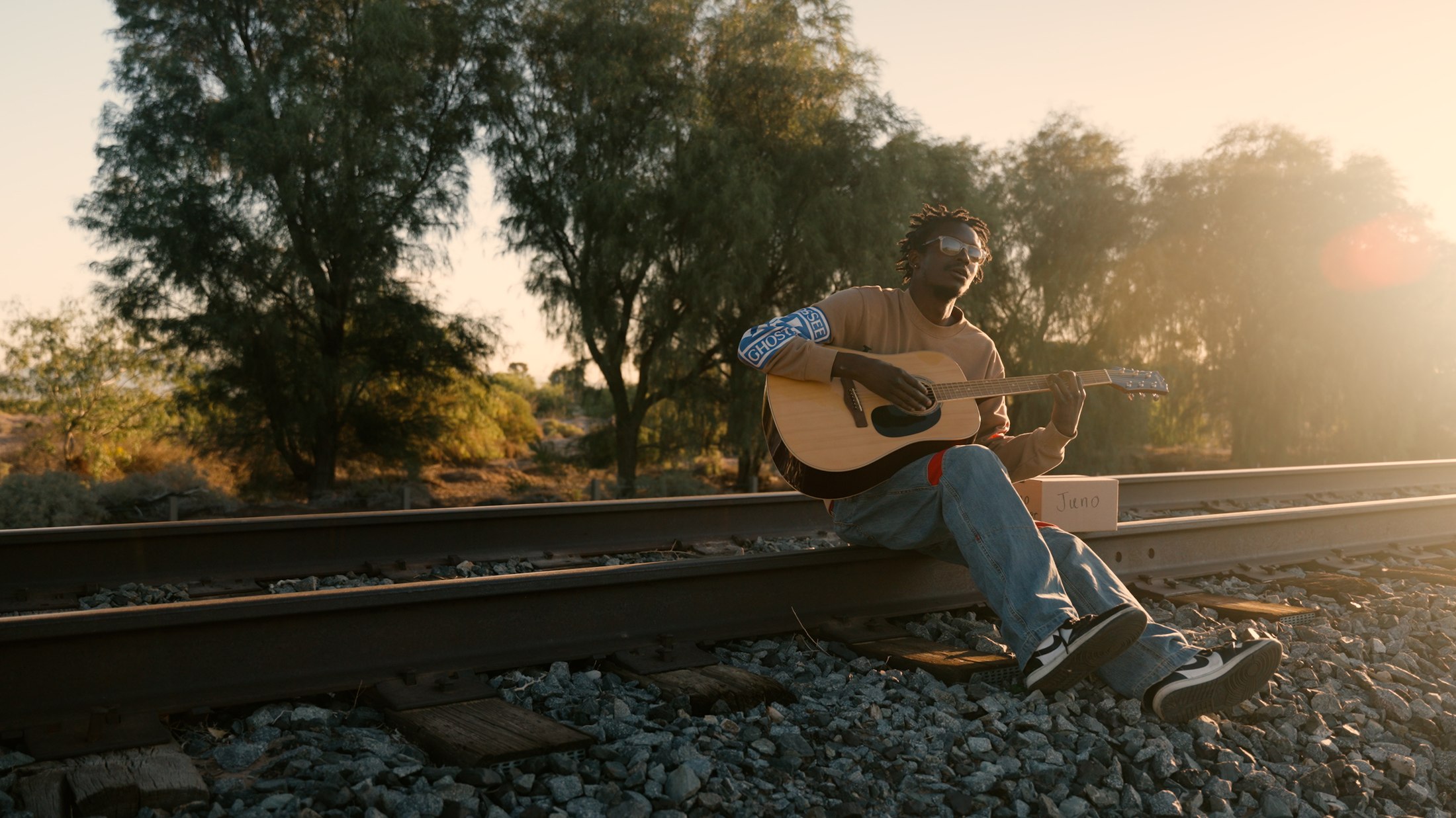 Musician with a guitar in warm evening light