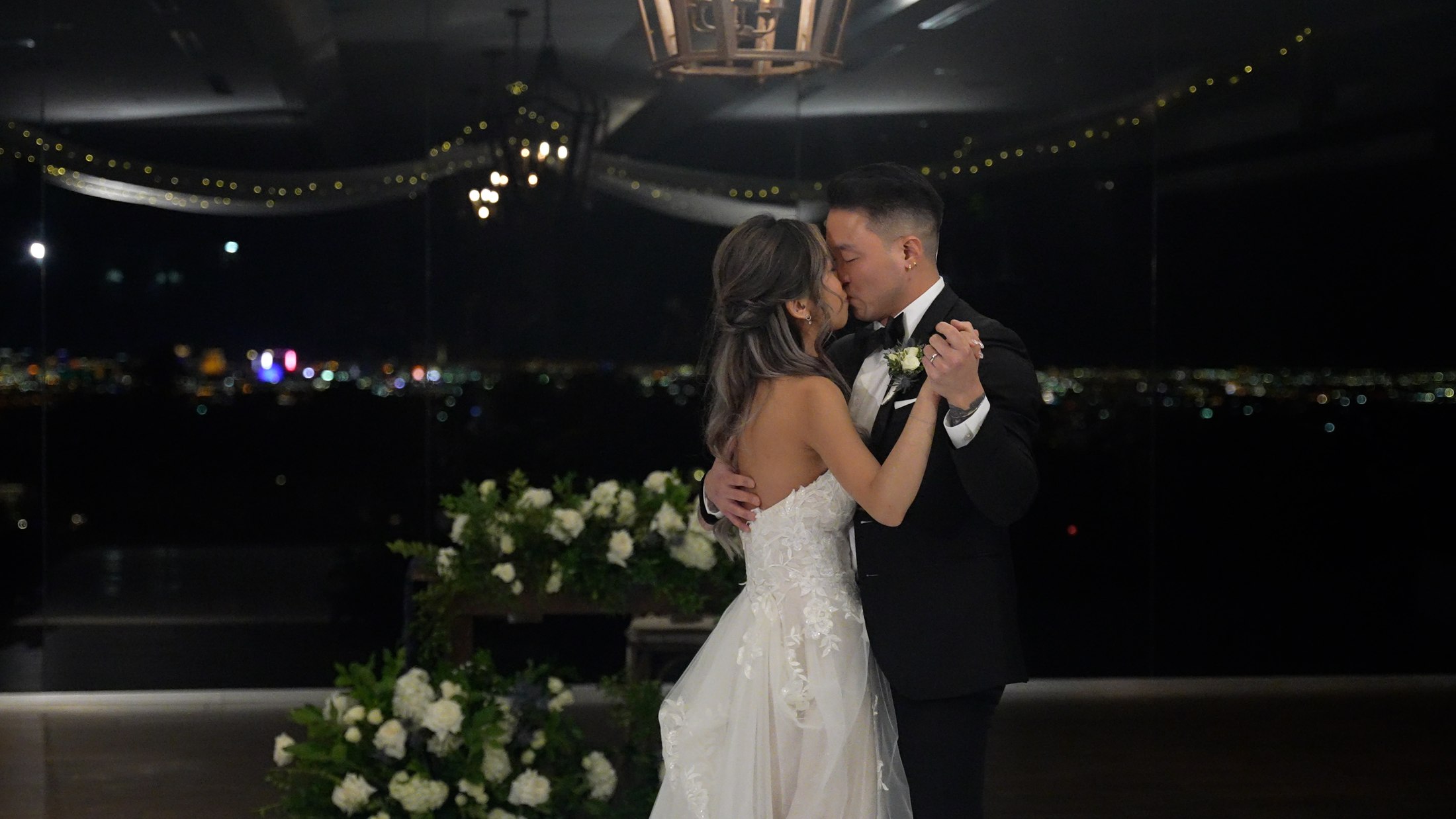 Wedding first dance beneath string lights